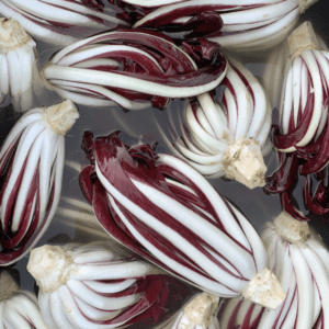 Fresh radicchio heads with distinctive white and purple leaves.